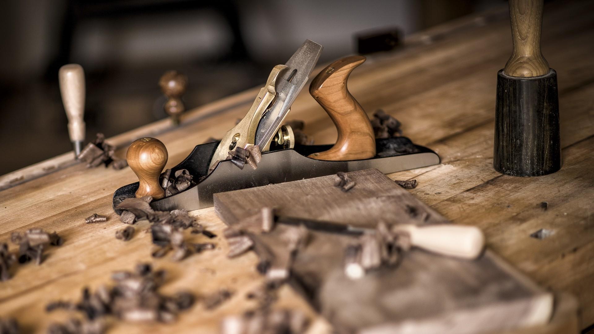 A hand plane resting on a woodworking bench
